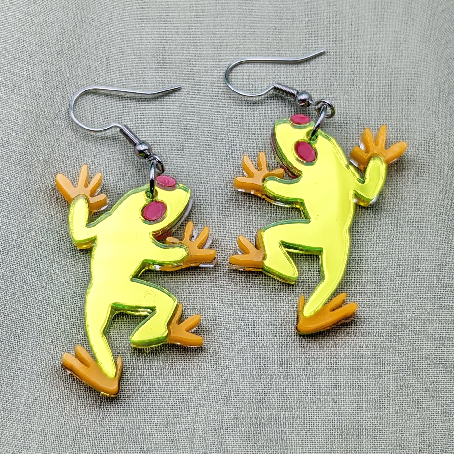 Neon green tree frog earrings with red eyes and orange feet on stainless steel fishhooks