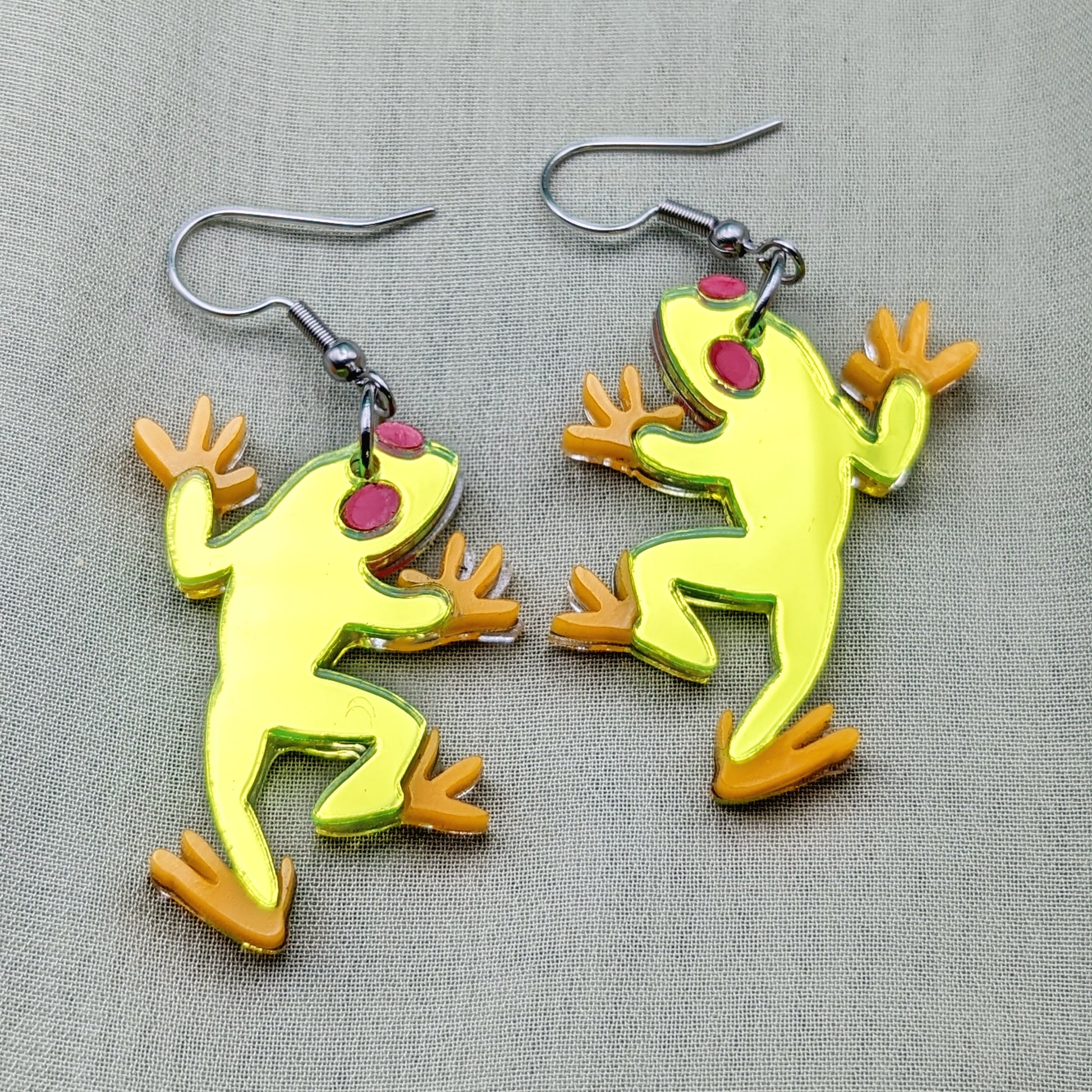 Neon green tree frog earrings with red eyes and orange feet on stainless steel fishhooks