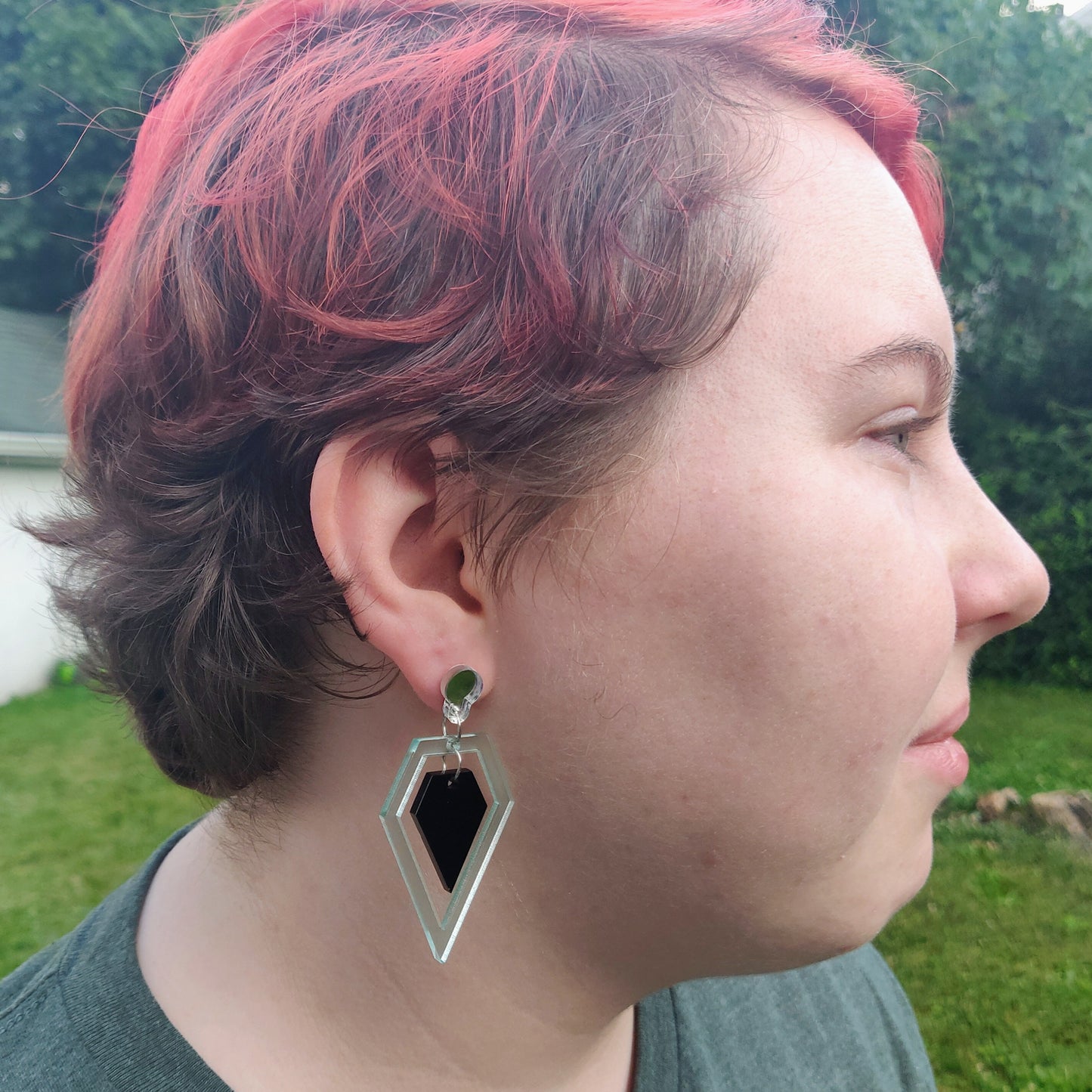 Geometric black and glass diamond shaped earrings on model