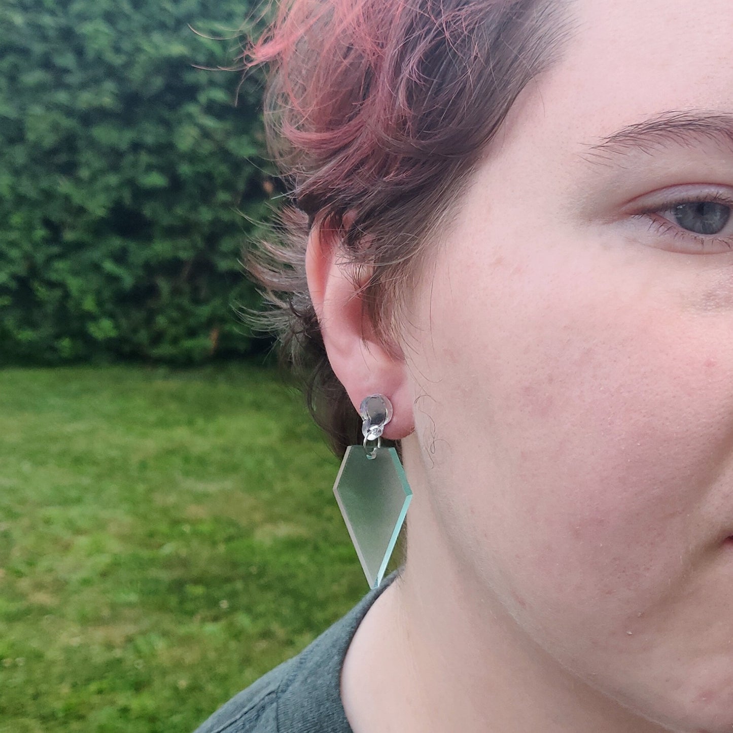 Glass diamond shaped earrings on model