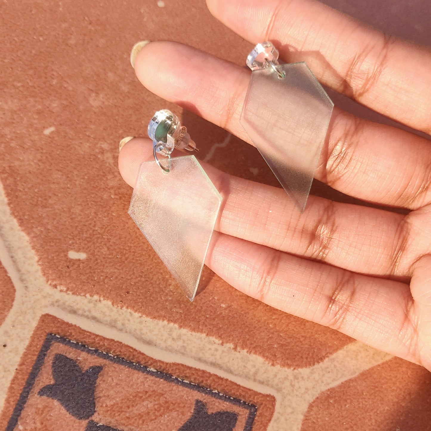 Glass diamond shaped earrings in hand