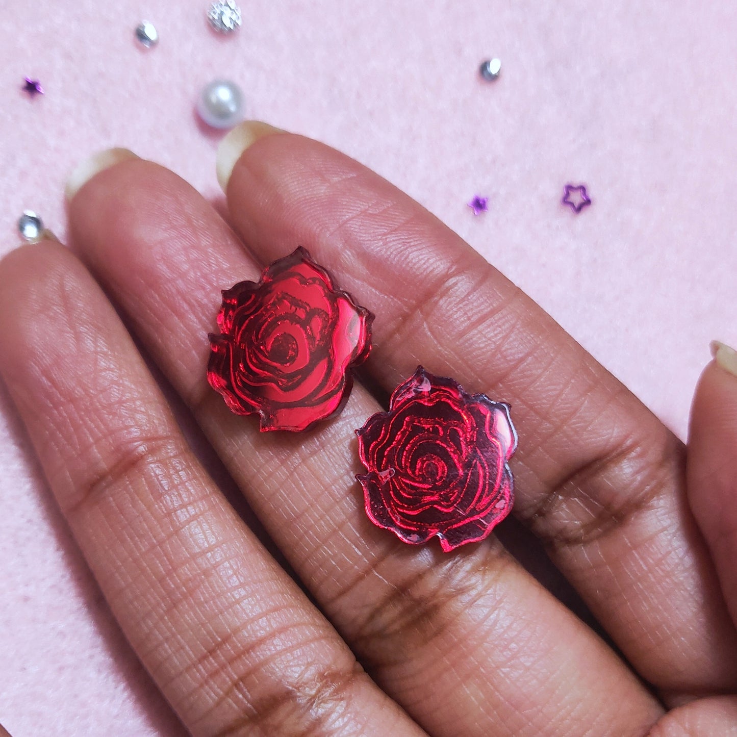 Red rose studs in hand