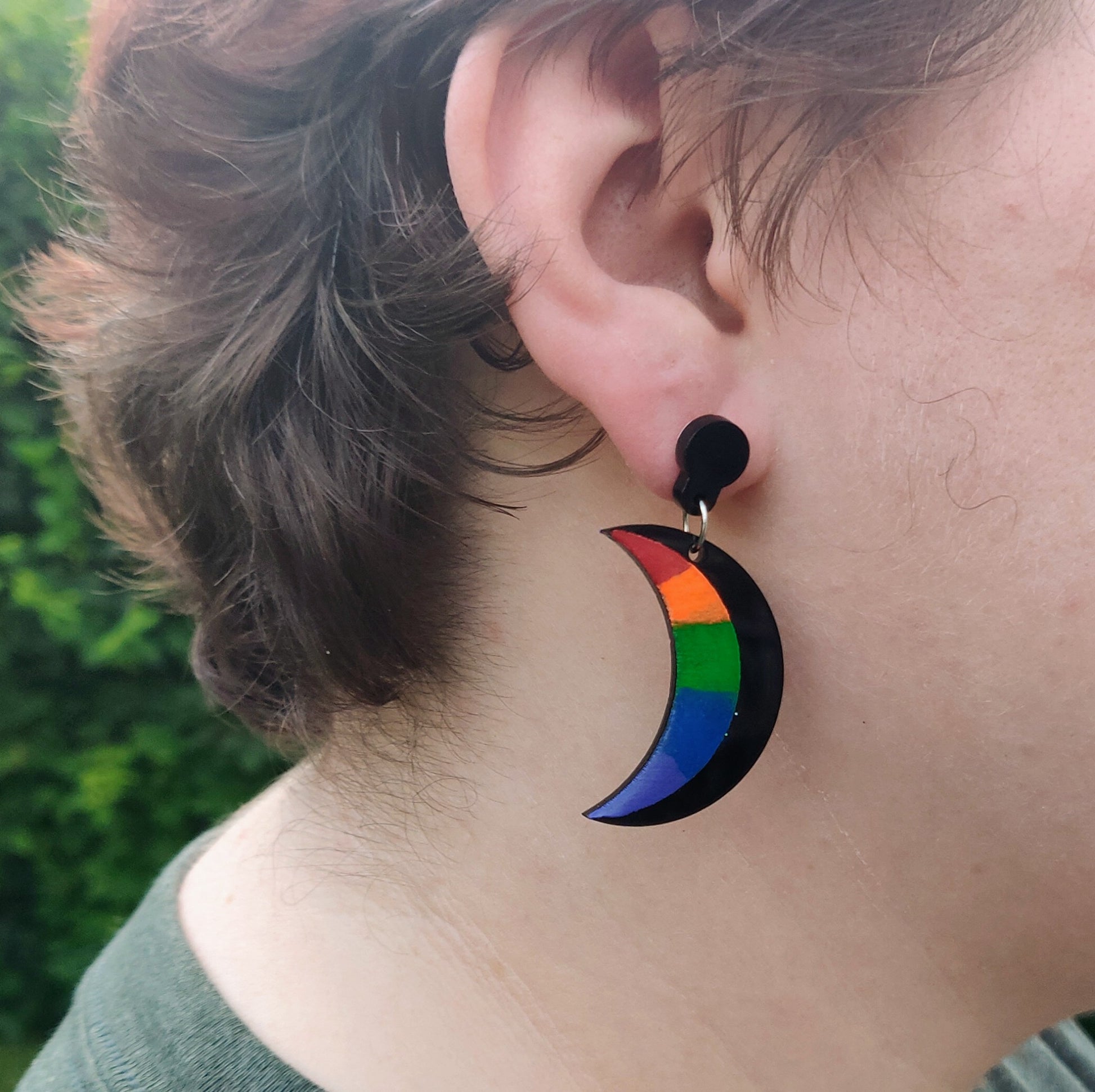 Rainbow and black crescent Moon earring on model