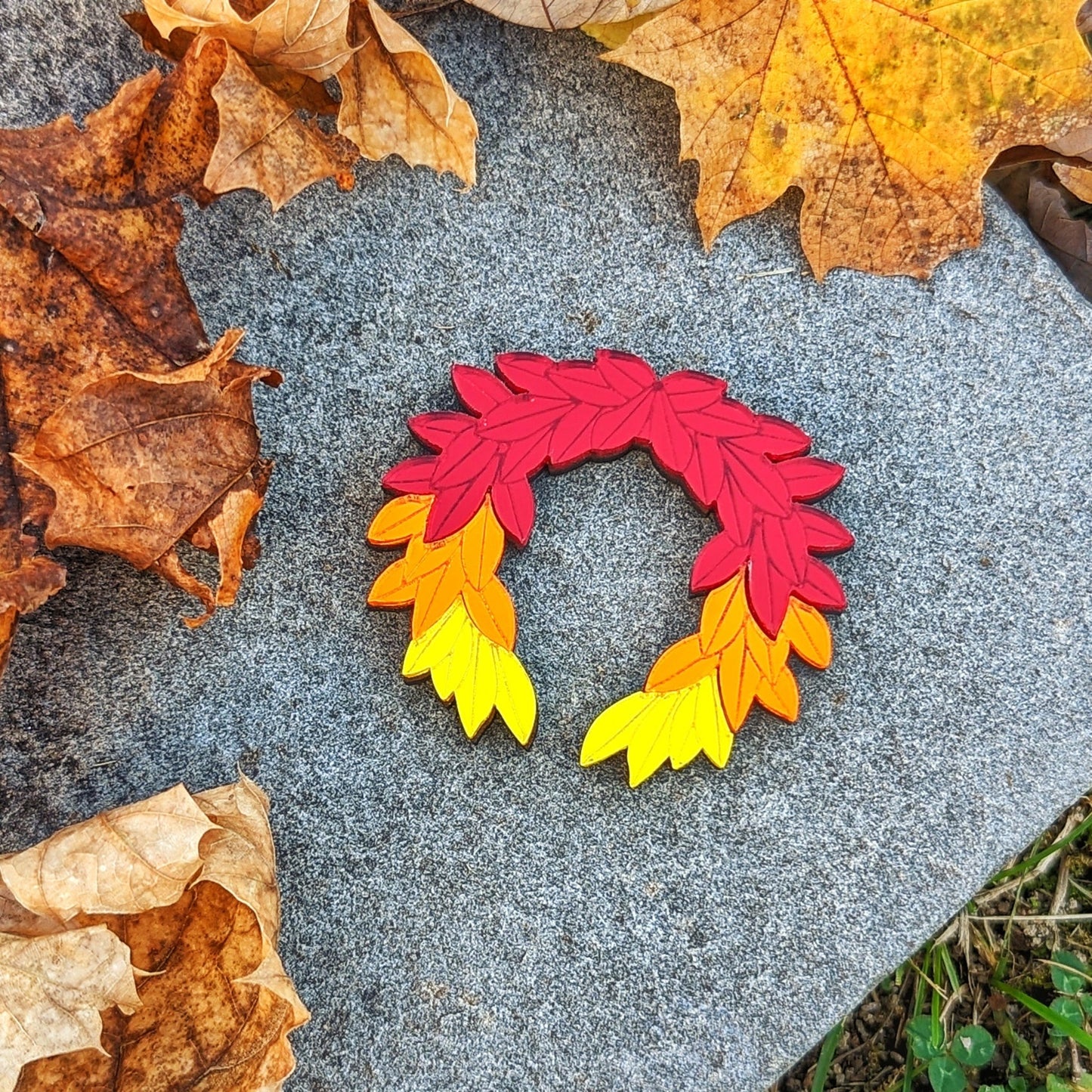 Hades game inspired fall brooch. Red orange and yellow leaves arranged in a laurel wreath shape.