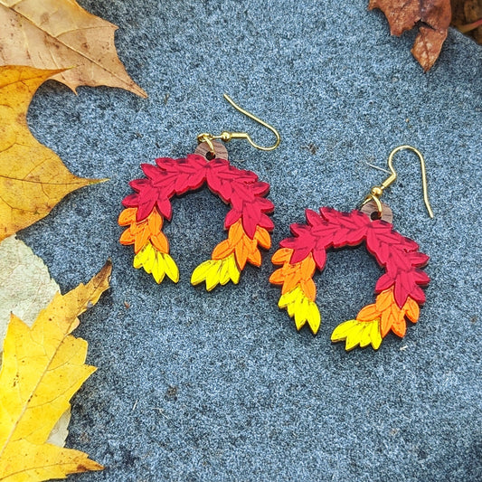 Hades game inspired fall earrings. Red orange and yellow leaves arranged in a laurel wreath shape.