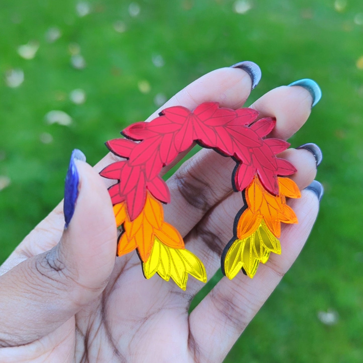 Hades game inspired fall brooch. Red orange and yellow leaves arranged in a laurel wreath shape.