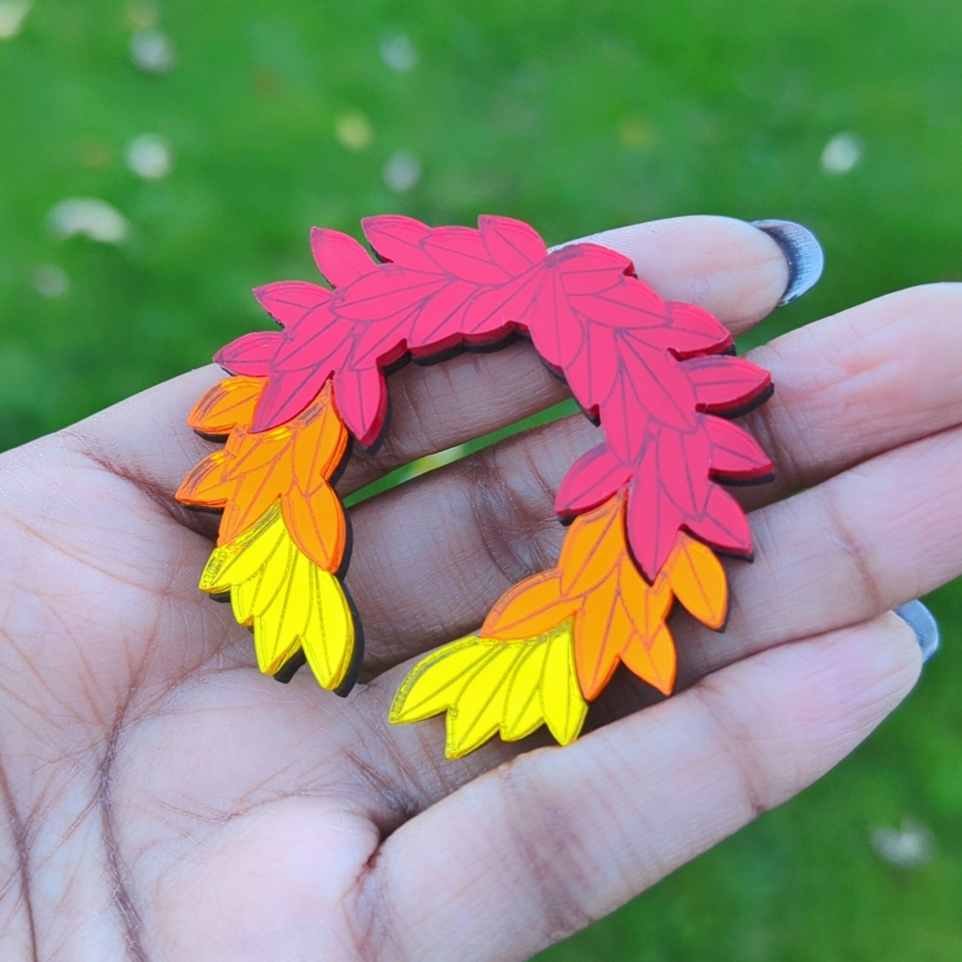 Hades game inspired fall brooch. Red orange and yellow leaves arranged in a laurel wreath shape.